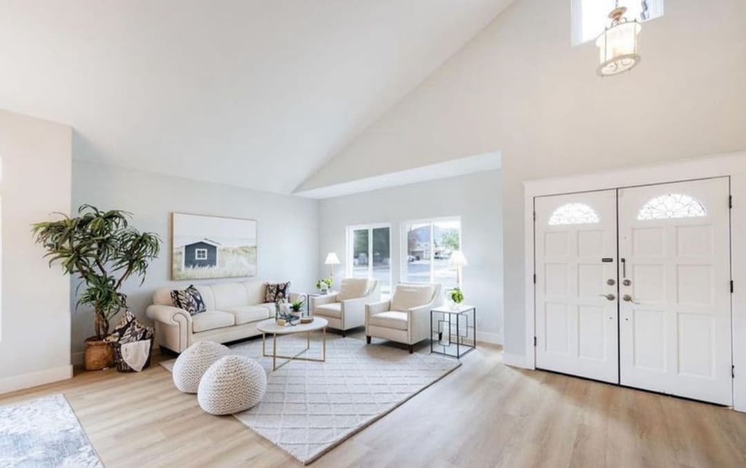 Bright and airy living room with cozy furniture, large windows, and stylish decor accents.