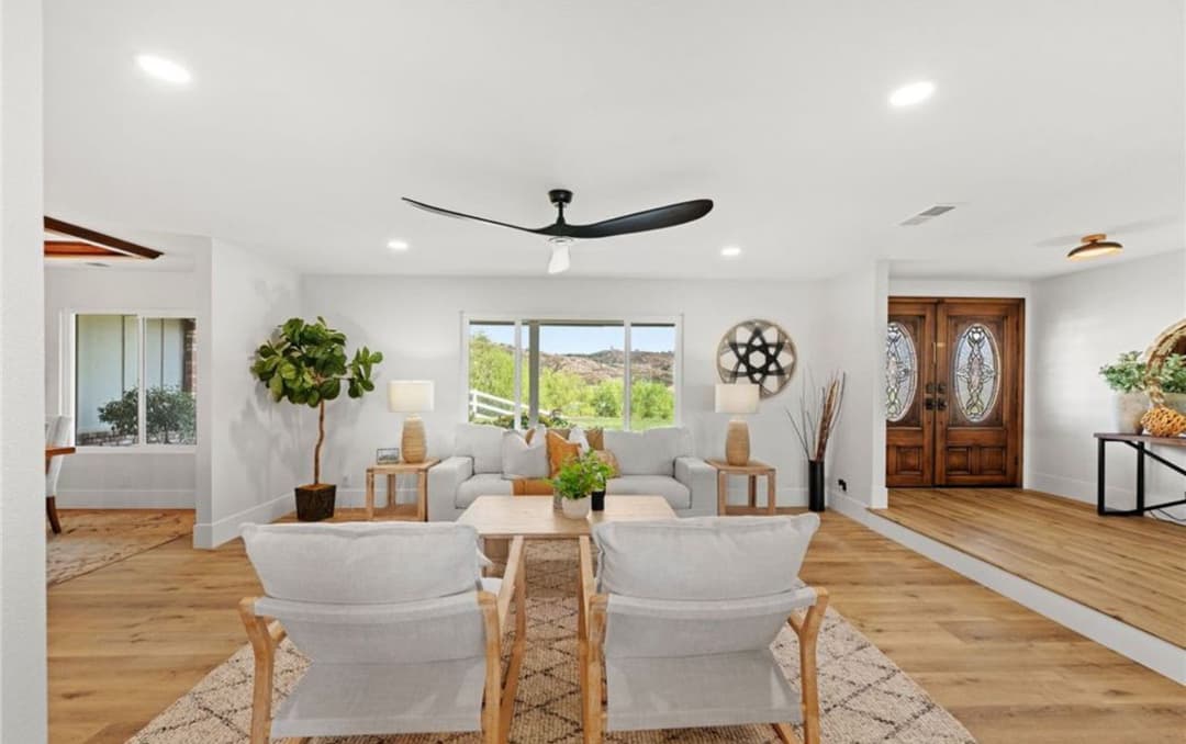 Modern living room with stylish furniture, natural light, and indoor plants. Inviting ambiance.