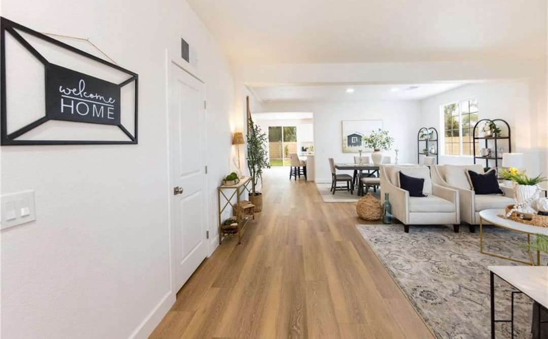 Spacious modern living room with natural light, welcoming decor, and cozy furnishings.