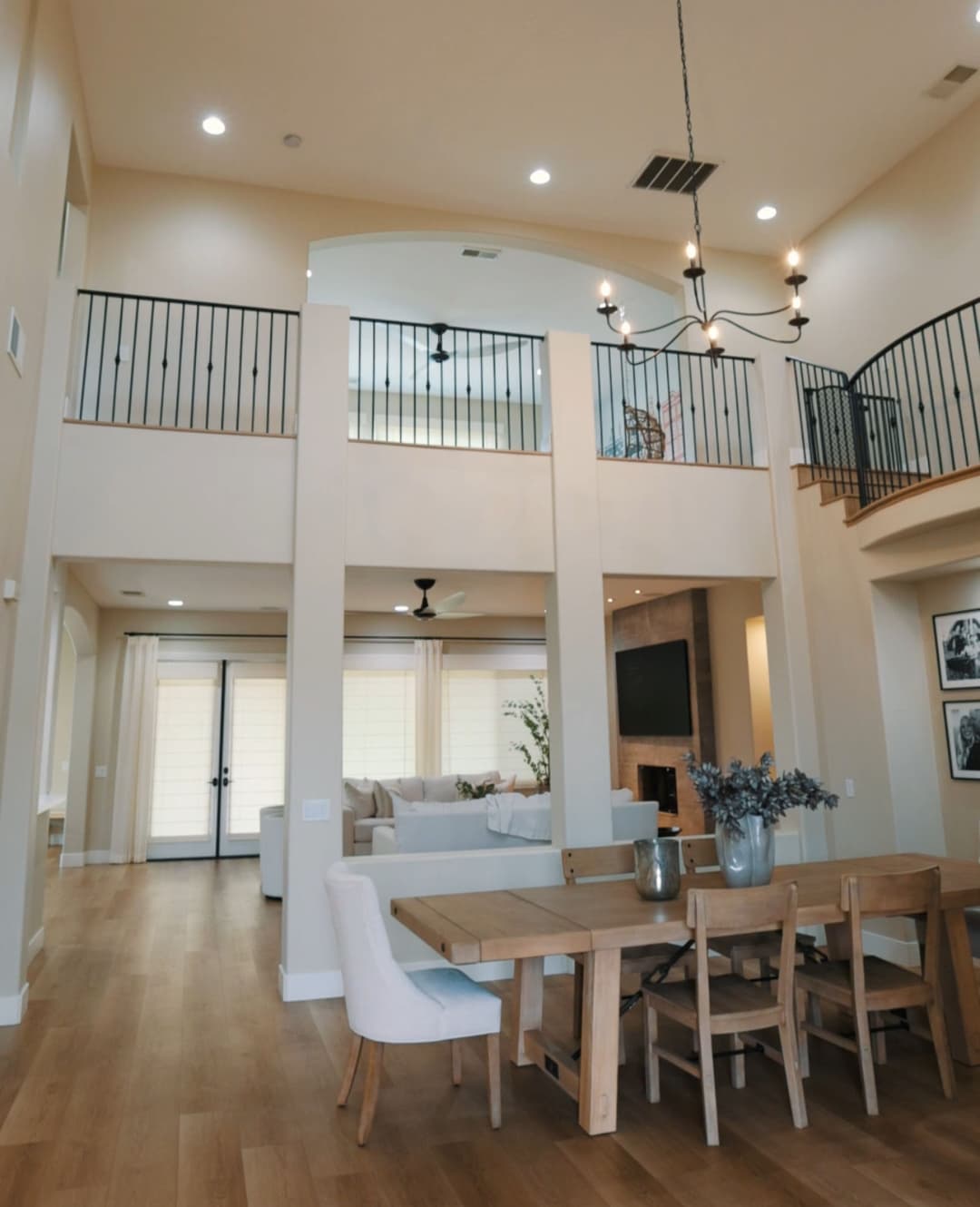 Modern open-concept living space with dining area, balcony, and stylish decor.