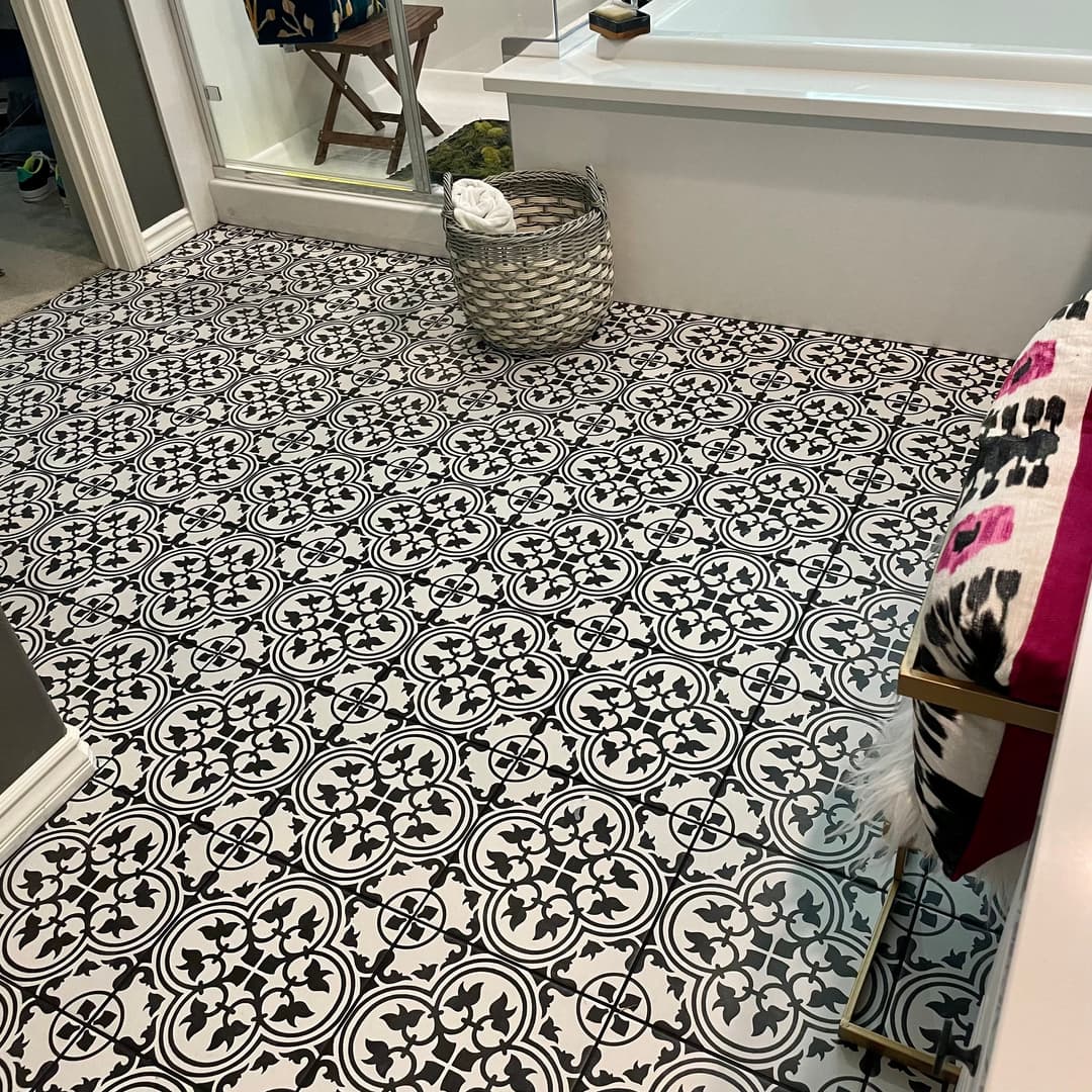 Black and white patterned tile floor in a modern bathroom with a stylish decor.
