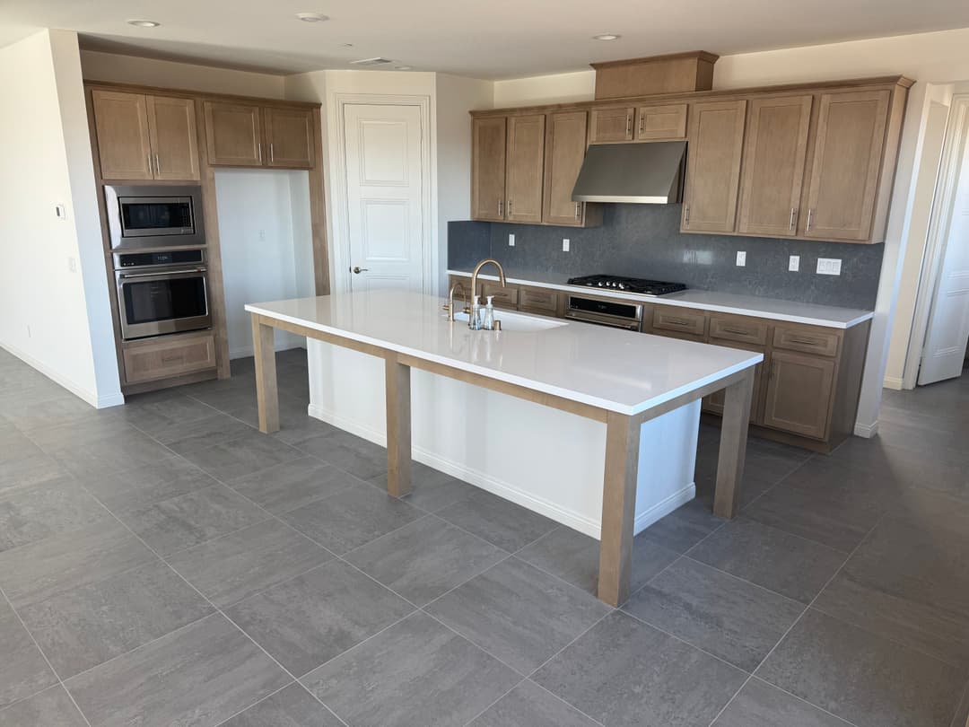 Modern kitchen with sleek cabinetry, island counter, and stainless steel appliances.