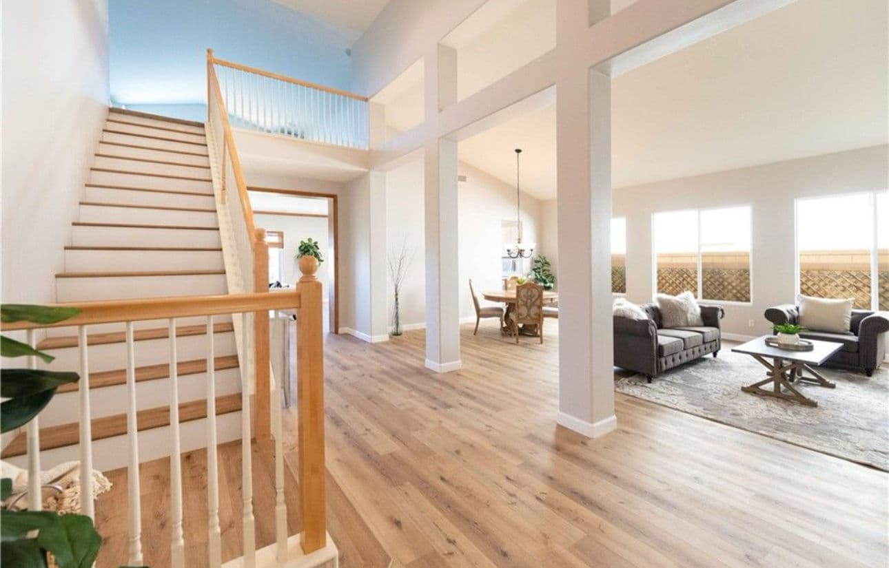 Spacious modern interior with staircase, living area, and natural light. Ideal family home.