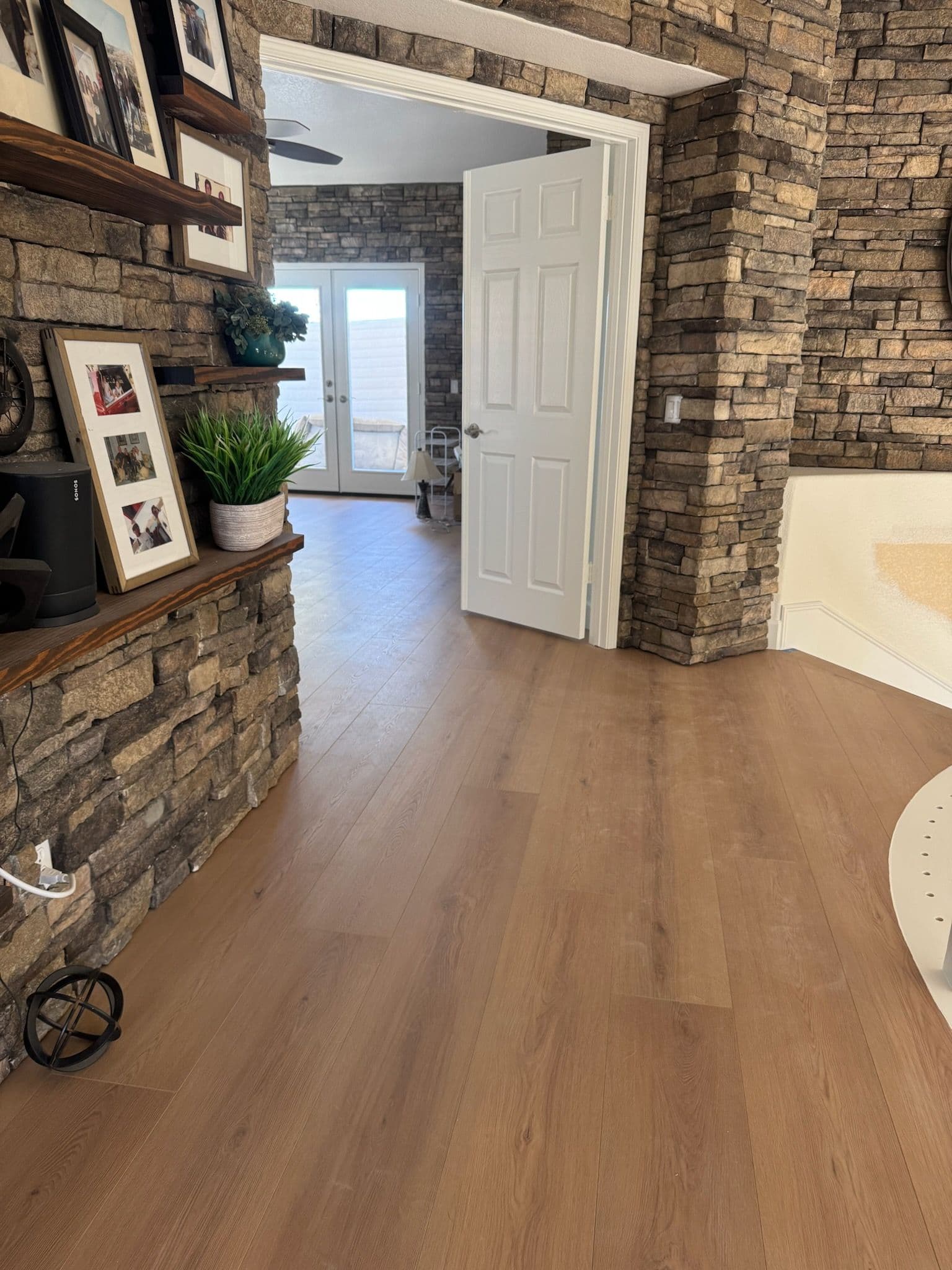 Revitalized Flooring Complements Rustic Stone Walls image